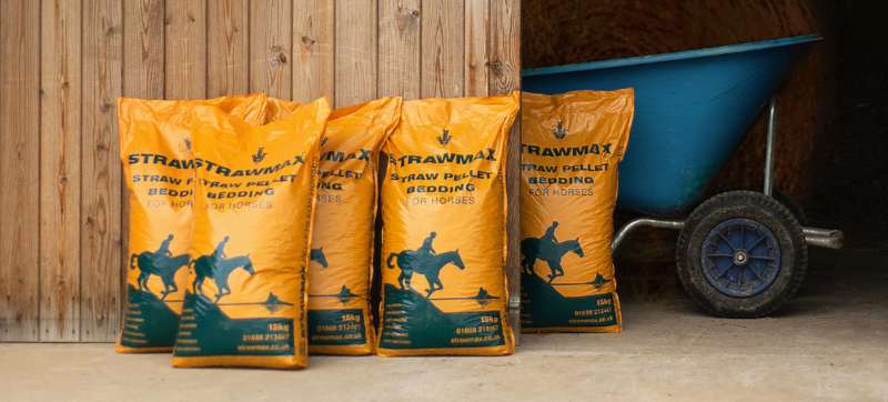 Bags of Strawmax by a stable door